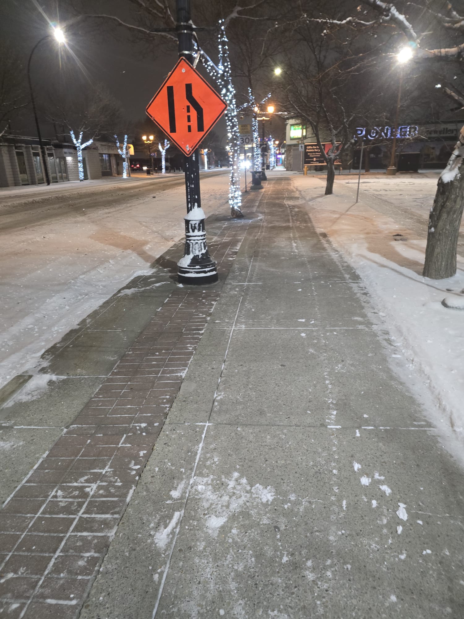 Cleared commercial sidewalk after overnight snow service in Edmonton