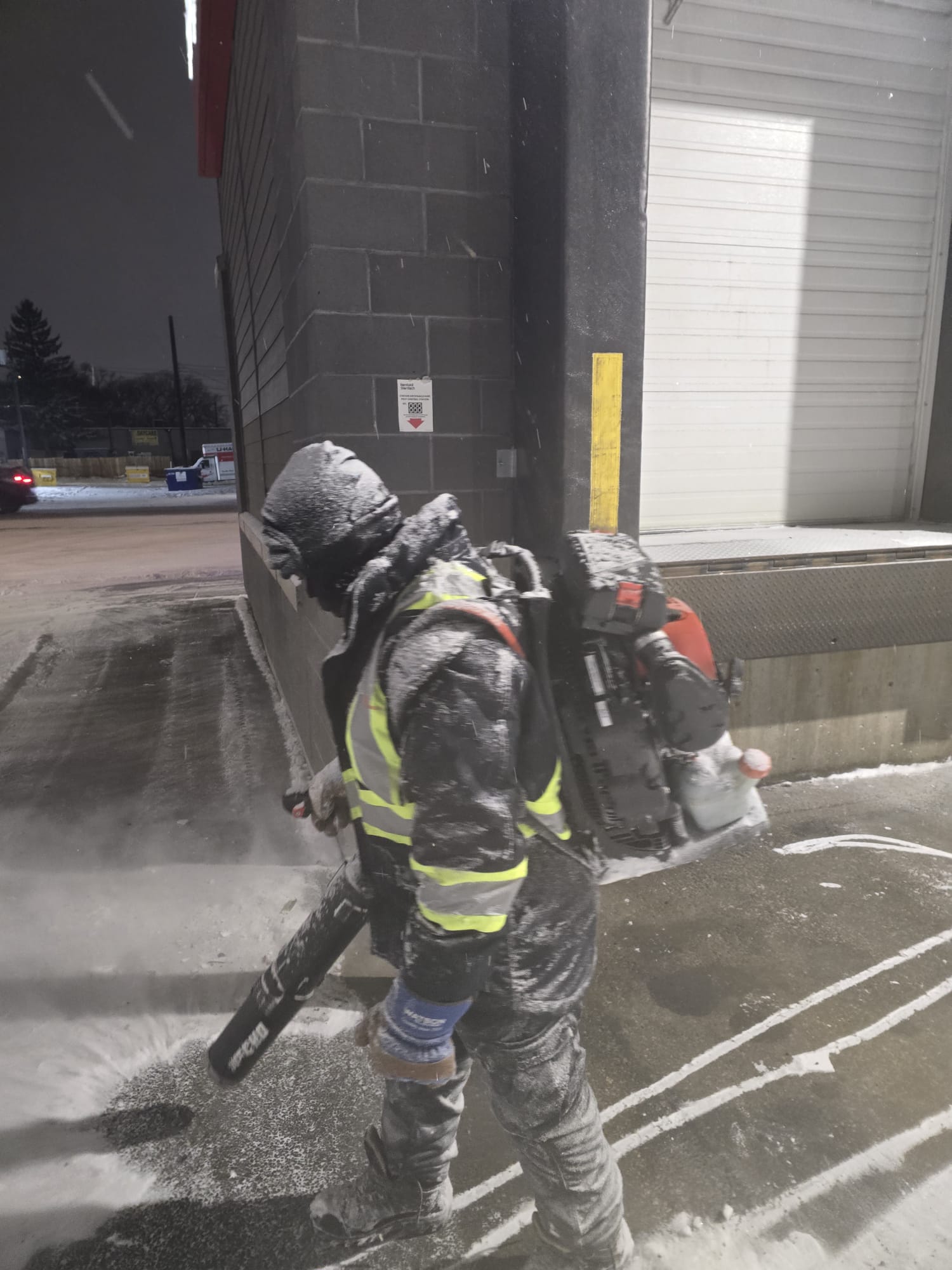 Hi-vis crew clearing a commercial building entry in Edmonton
