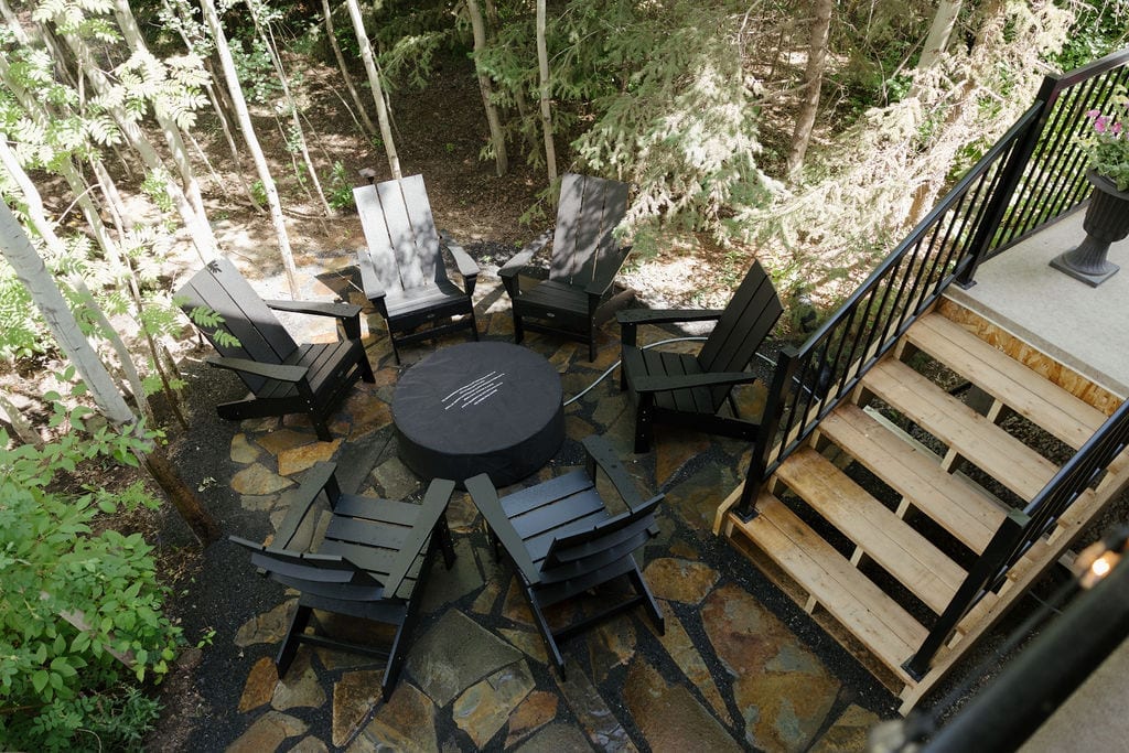 Flagstone patio at the foot of new deck stairs, built by Zebra Landscaping
