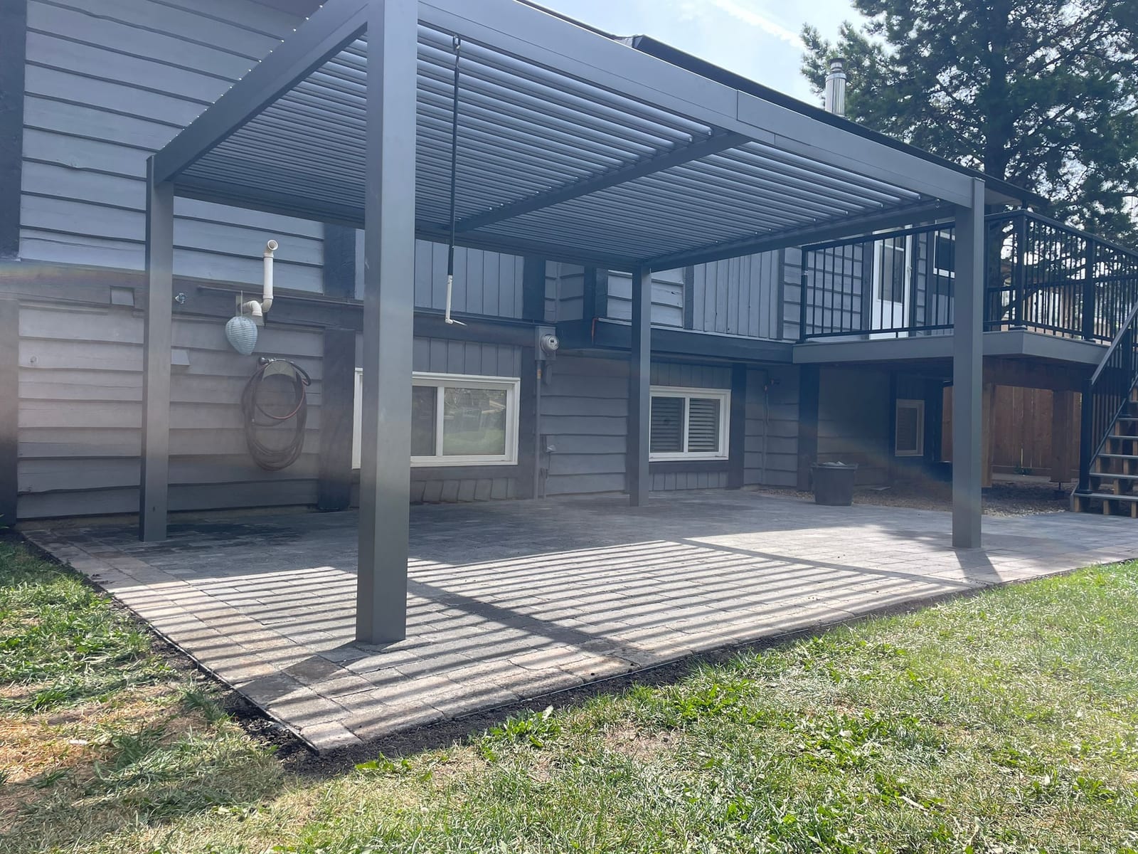 Modern pergola over a paver patio built by Zebra Landscaping