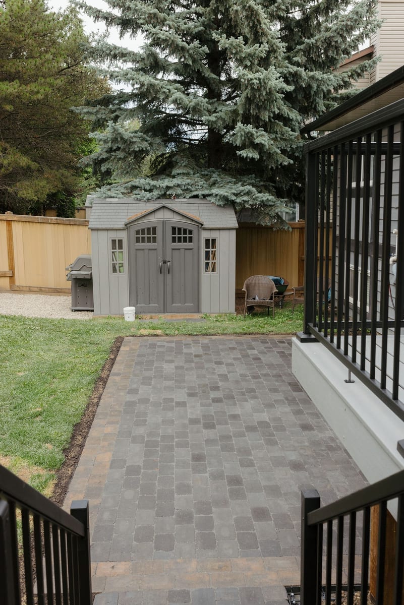 Paver path leading to a backyard shed