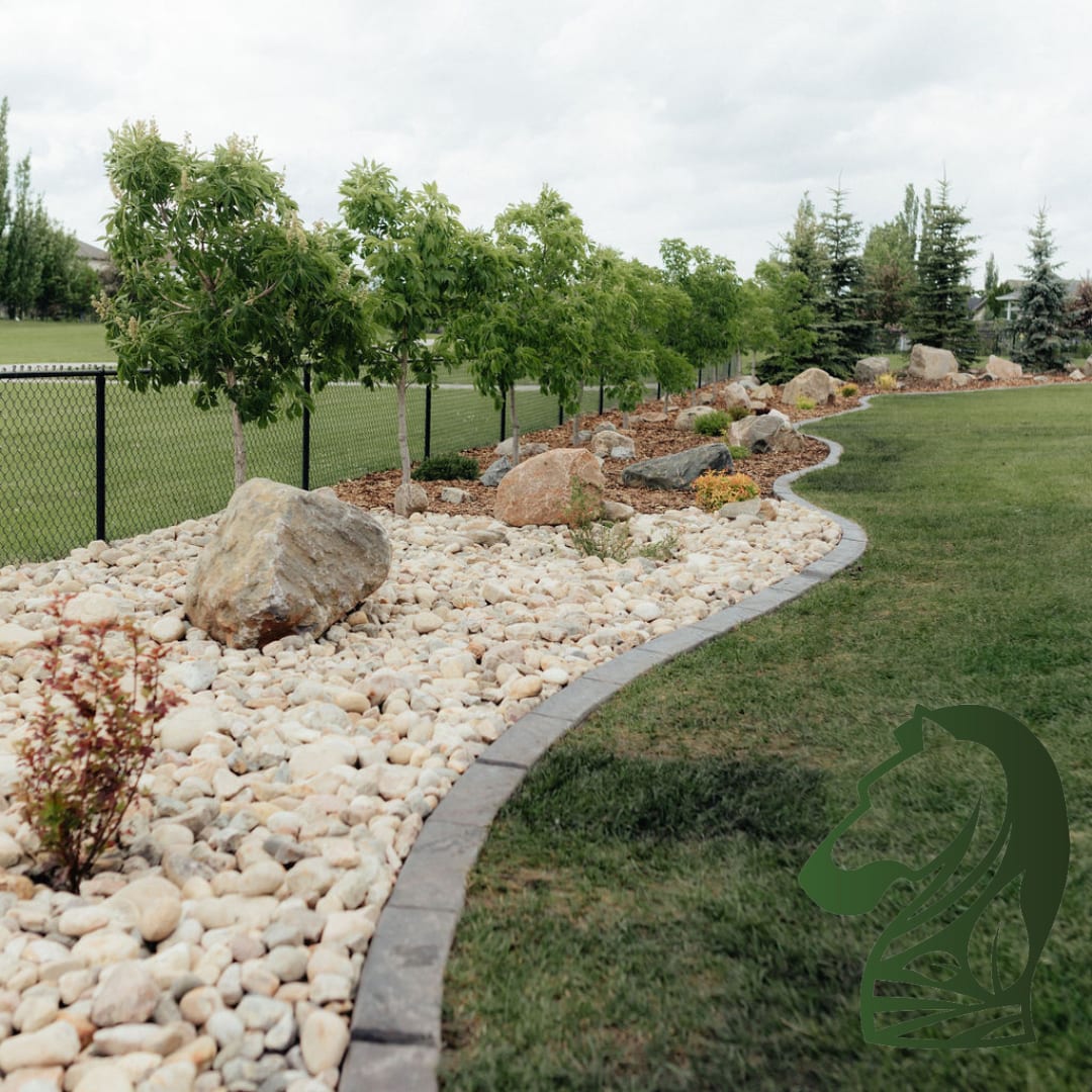 River rock bed with boulders and curved concrete edging