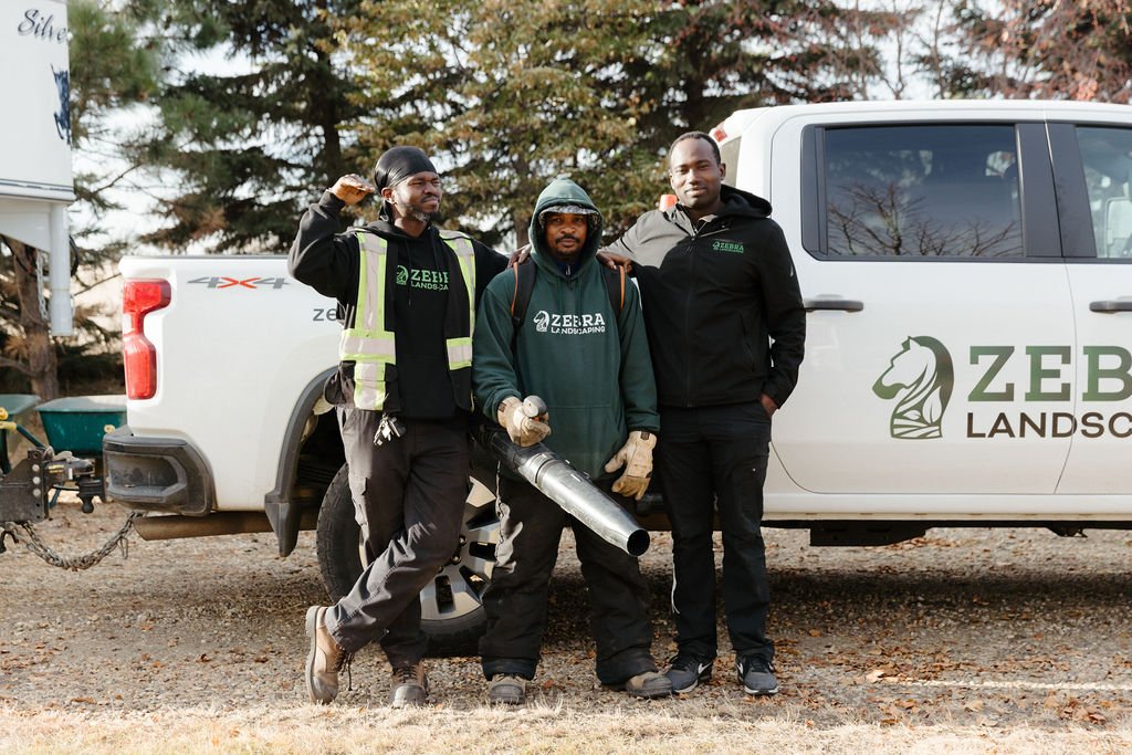 Zebra Landscaping crew beside a company truck