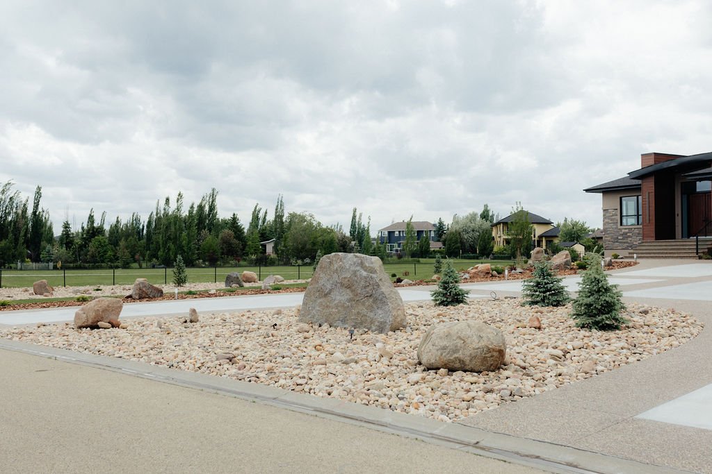 Front yard rock garden with boulders and shrubs